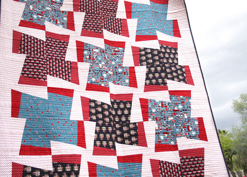 Fan-tastic quilt with clouds in the background. 