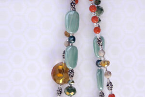 Teal, orange and brown beads are featured in the Baby and Me Jewelry Set