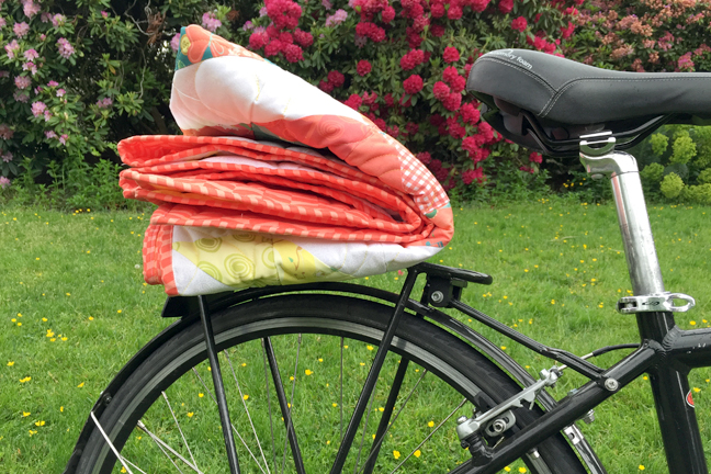 quilt folded and placed on a bike