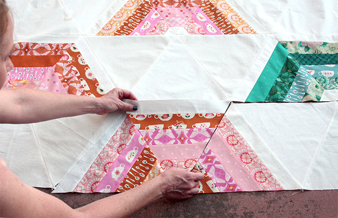 The Color Turn Quilt is created with Triangles. Here I am laying out the pieces for the quilt. 