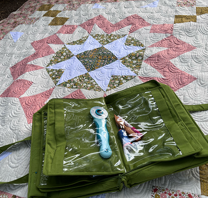 My quilting bag is the focus in this image. It is on top of the quilt top. 